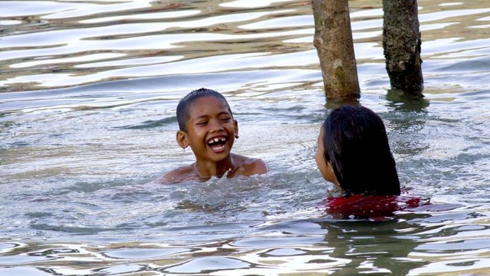 Kids playing in the sea.